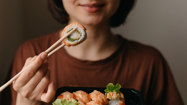 person eating sushi