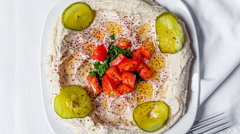 hummus with sliced pickles on top