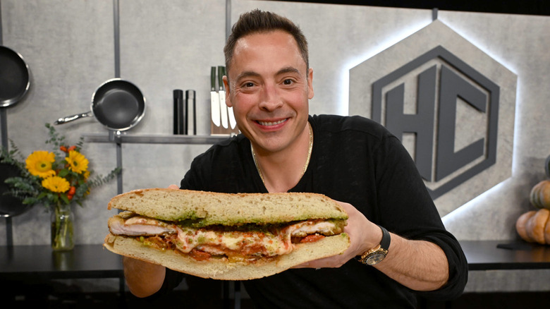 Jeff Mauro holding a massive sandwich