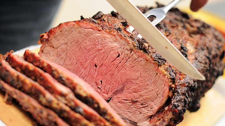 Close-up of a foodie carving prime rib