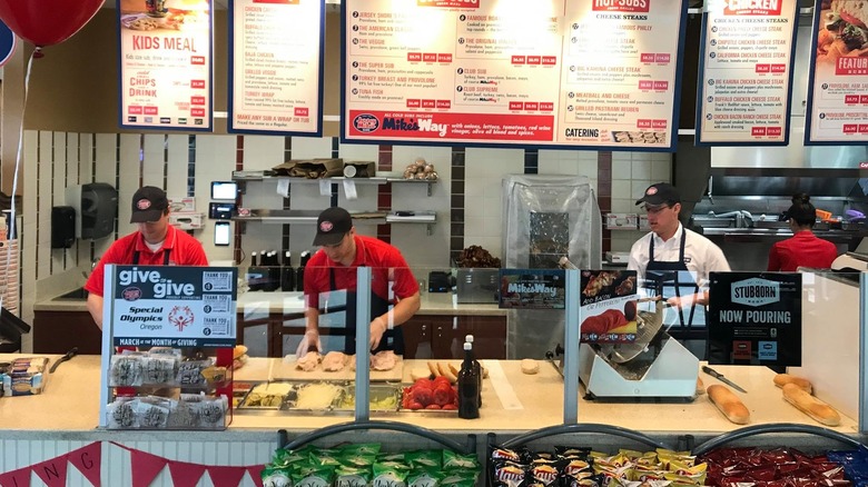 Jersey Mike's workers behind the counter making sandwiches