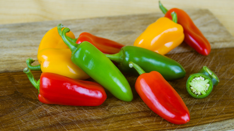 A pile of assorted red, green, and yellow peppers