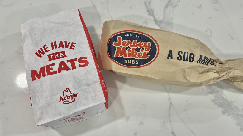 Arby's and Jersey Mike's roast beef sandwiches in to-go bags
