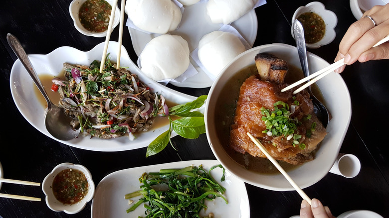Plates of Yunnan food with chopsticks