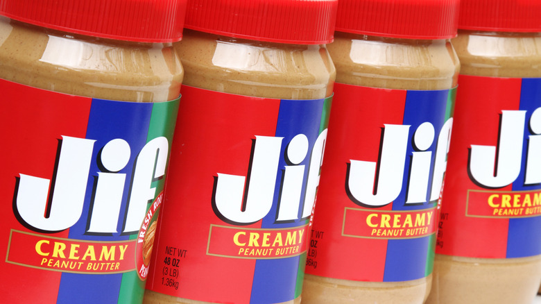 Four containers of Jif peanut butter in a row