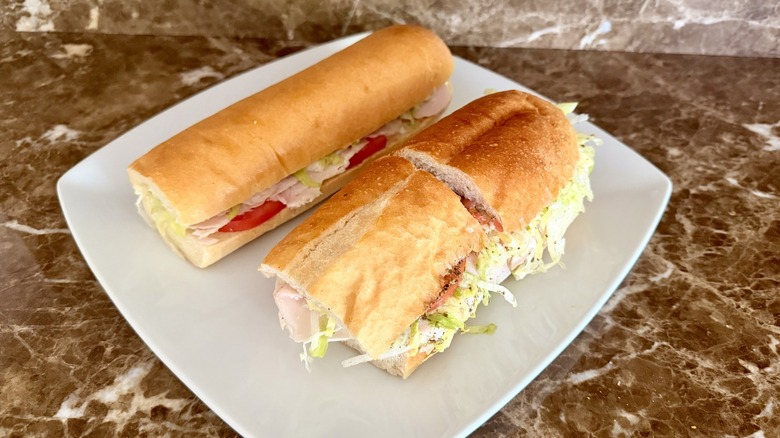Jersey Mike's Turkey and Provolone and Jimmy John's Turkey Tom subs on a white plate