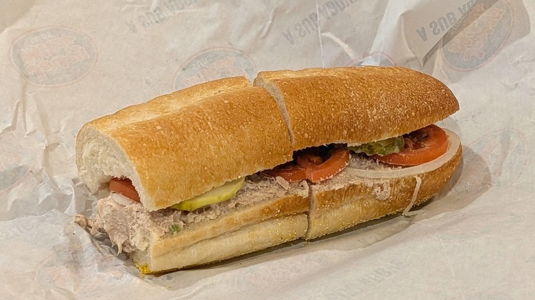 A tuna sub from Jersey Mike's on branded white paper