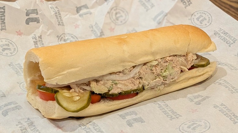 A tuna sub from Jimmy John's on branded white paper