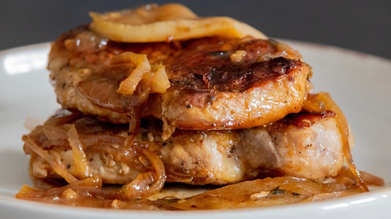 Close-up of pork chops with fried apples