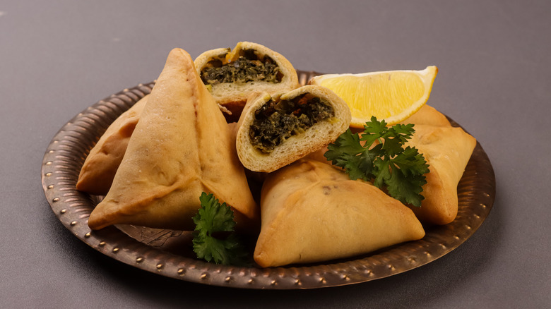 Fatayer on a plate with a lemon wedge
