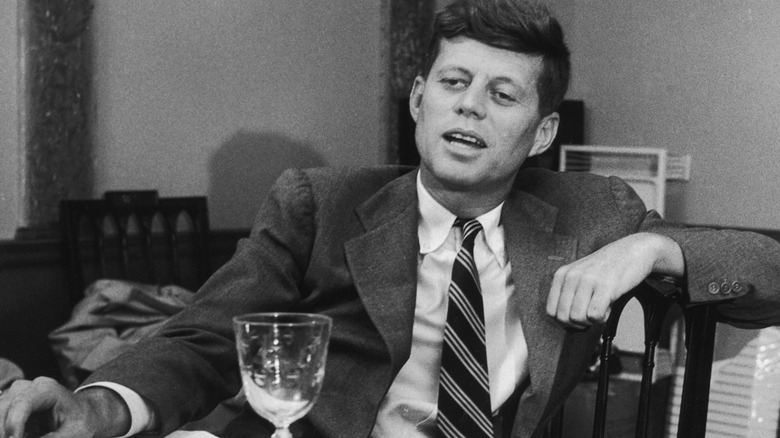 Former President John F. Kennedy sitting at the dinner table