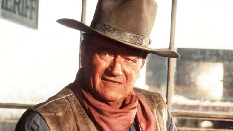 John Wayne in a cowboy hat on a film set