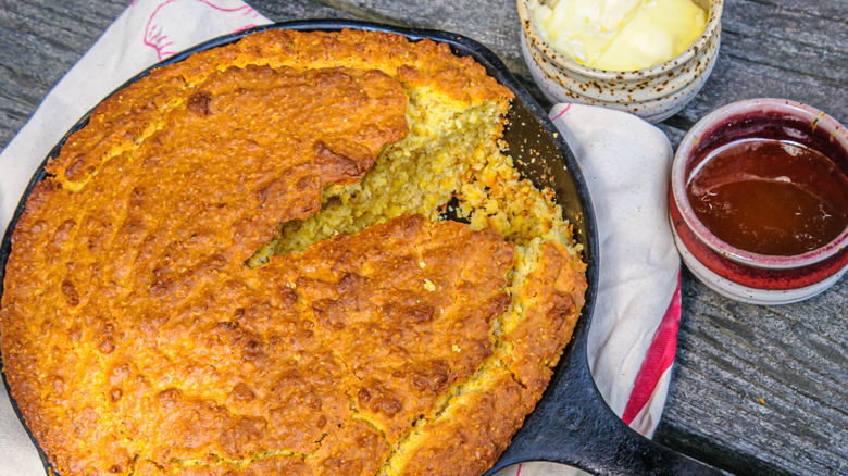 Cornbread in a cast iron skillet with sauces