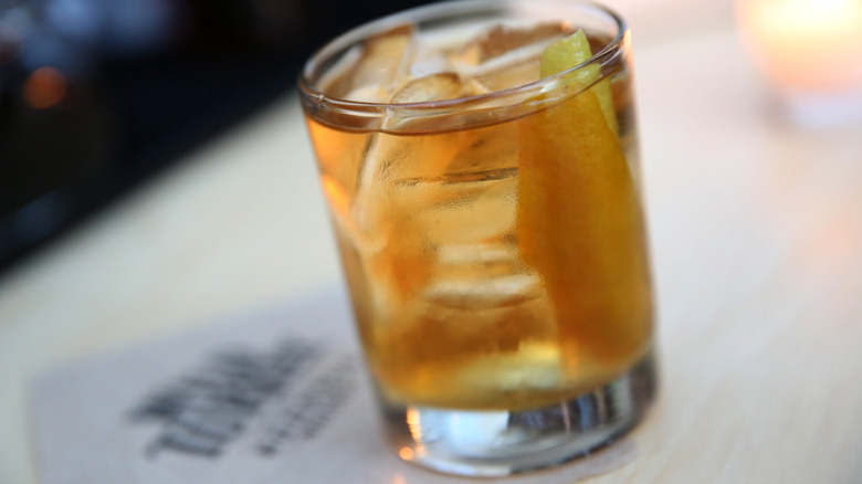 a bourbon cocktail in a rocks glass with ice