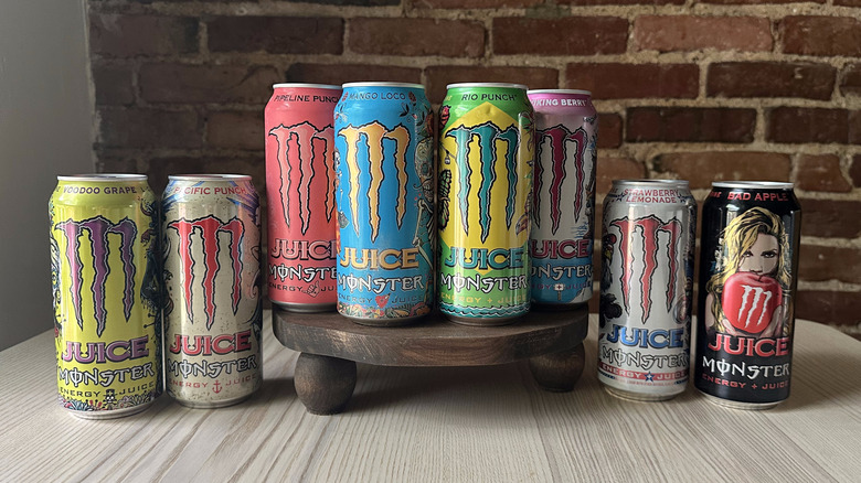 Juice Monster cans arranged on wooden table