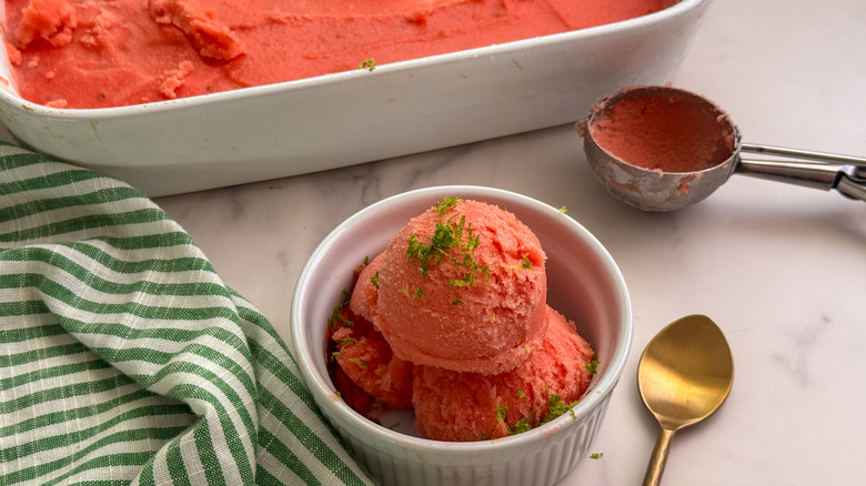 white bowl with watermelon sorbet and lime zest
