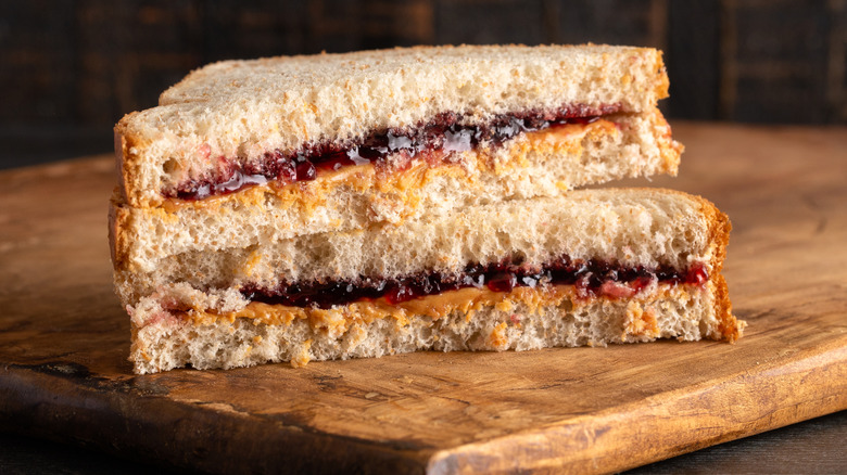 Peanut butter and jelly sandwich on cutting board