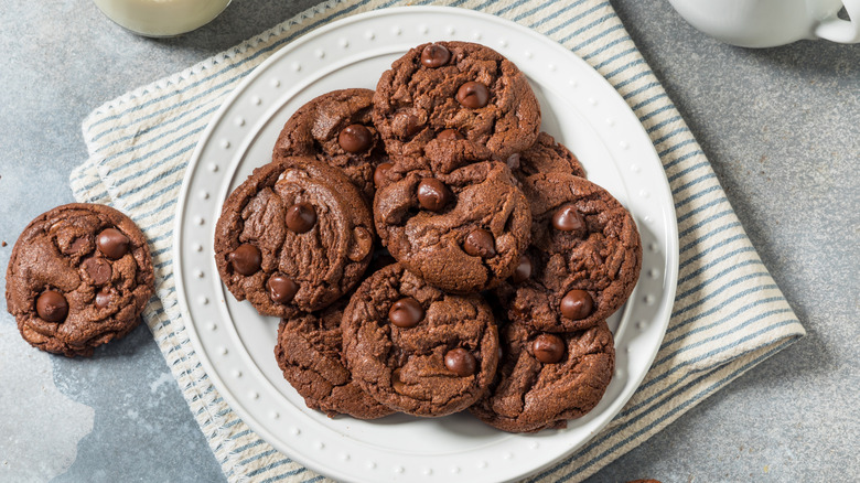 A plate piled high with double chocolate chip cookies