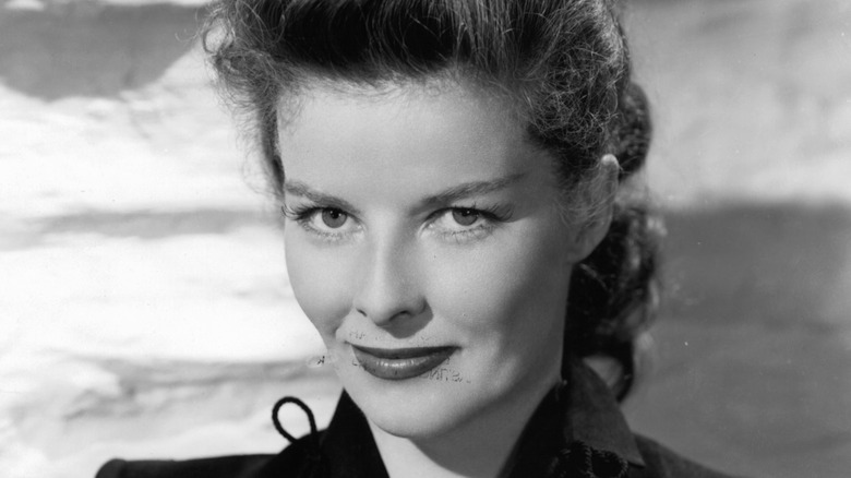 Katharine Hepburn smiles with hair in updo