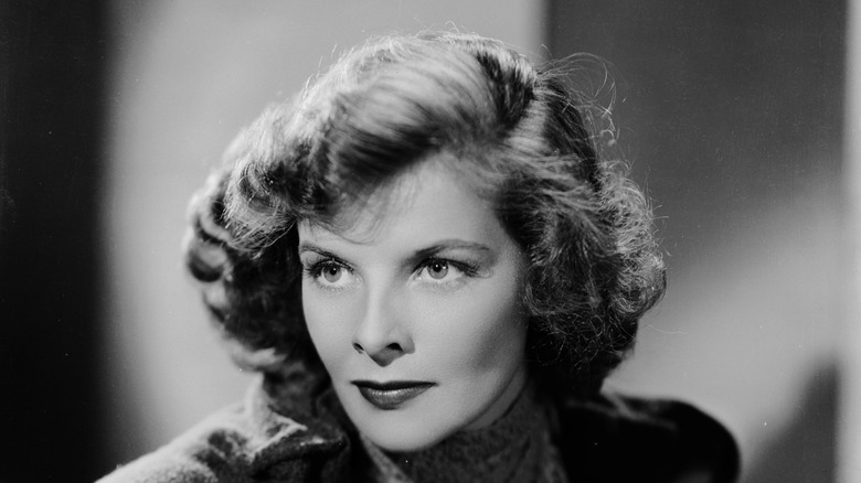 A black and white image of Katharine Hepburn looking off to the left, wearing a dark sweater