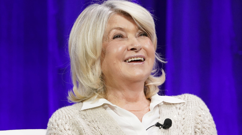 Head and shoulders of Martha Stewart smiling with mic attached to sweater.