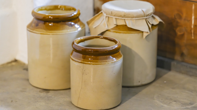 A set of 3 vintage beige and brown crocks