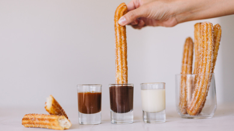 Churros with condensed milk, chocolate, and caramel sauce
