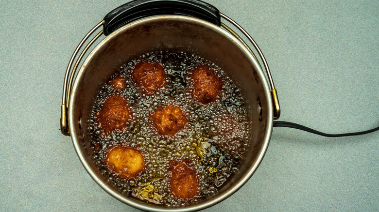 hush puppies frying in peanut oil