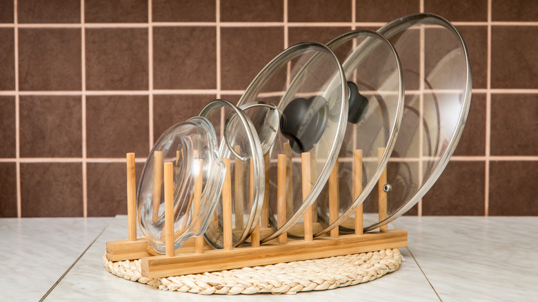 Pan lids in wooden dish rack
