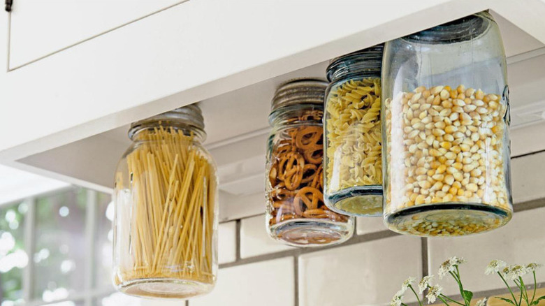 mason jars floating underneath kitchen cabinet