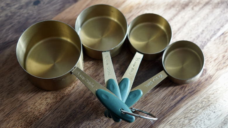 Ring of measuring cups fanned out on wooden counter