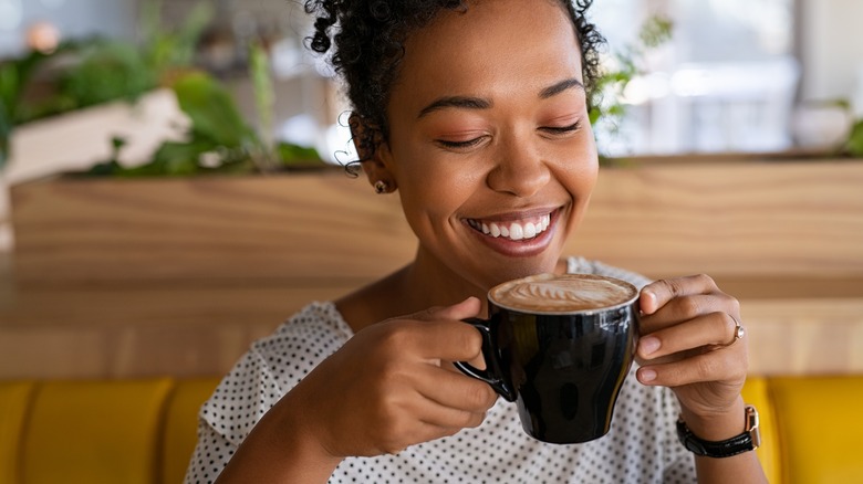 Person smiling with coffee