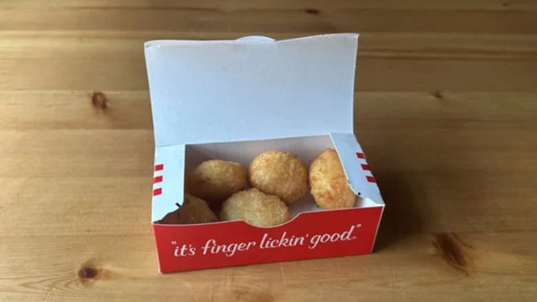 box of mashed potato poppers on a wooden table