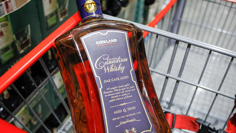 Bottle of Kirkland Signature Canadian Whisky in Costco shopping cart