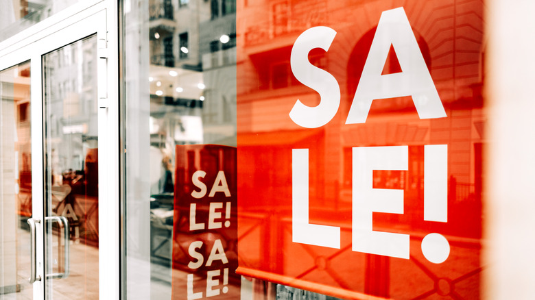 A sale sign inside a store window