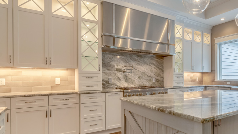 a kitchen with glass-fronted kitchen cabinets