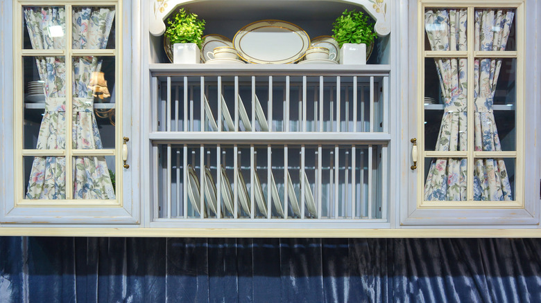 curtains on glass-fronted kitchen cabinets