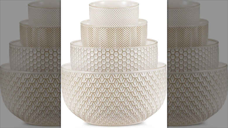Four white nesting ceramic mixing bowls
