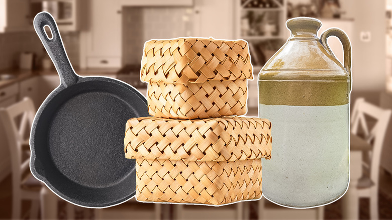 Rattan baskets, a cast iron skillet, and vintage pitcher against the blurred background of a country kitchen
