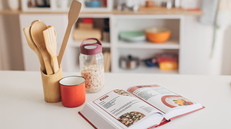 open cookbook on white kitchen counter