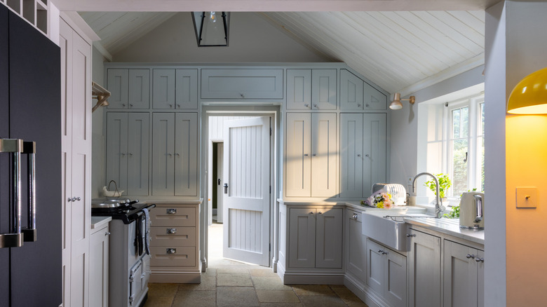 View of kitchen with cornflower blue cabinets