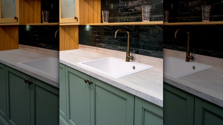 View of sage green and tiled kitchen