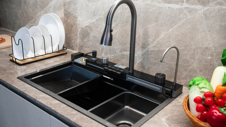 Modern kitchen sink with black faucet