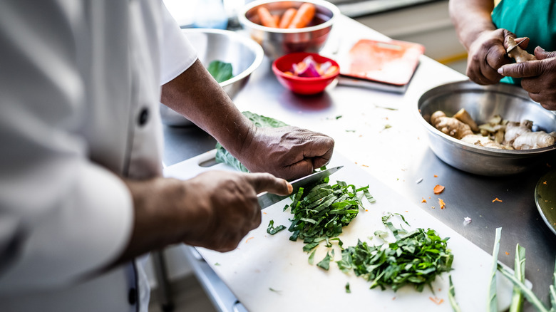 Human hands chopping vegetables