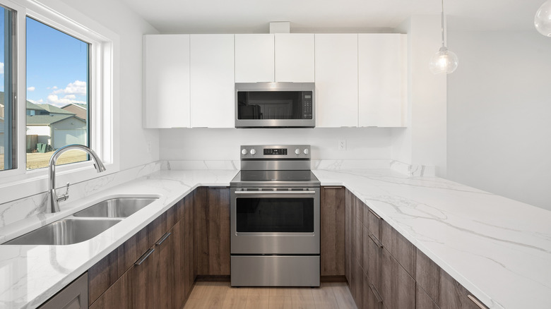 white kitchen with clean counters and shelves