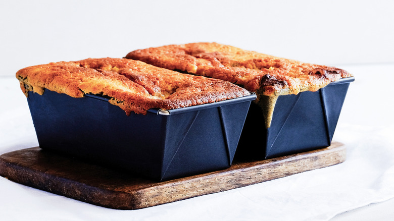 Two loaf cakes cooling in pans