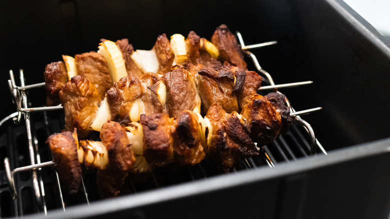 Pork kebabs on metal skewers in air fryer