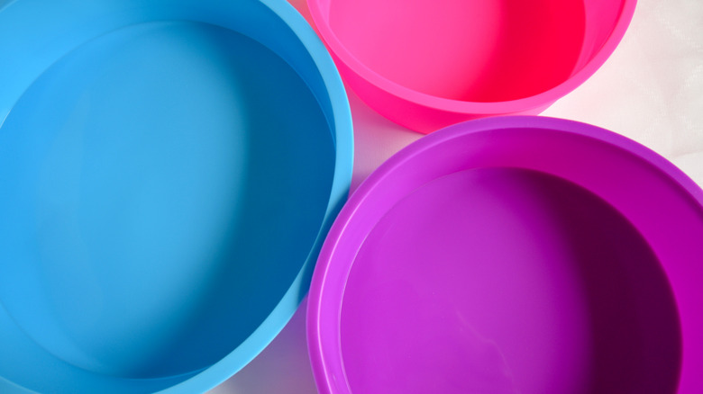 Three brightly-colored silicone cake molds