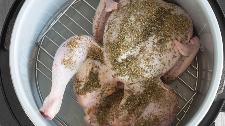 Whole herb-covered chicken on air fryer rack