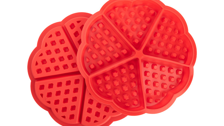 Two red silicone waffle molds